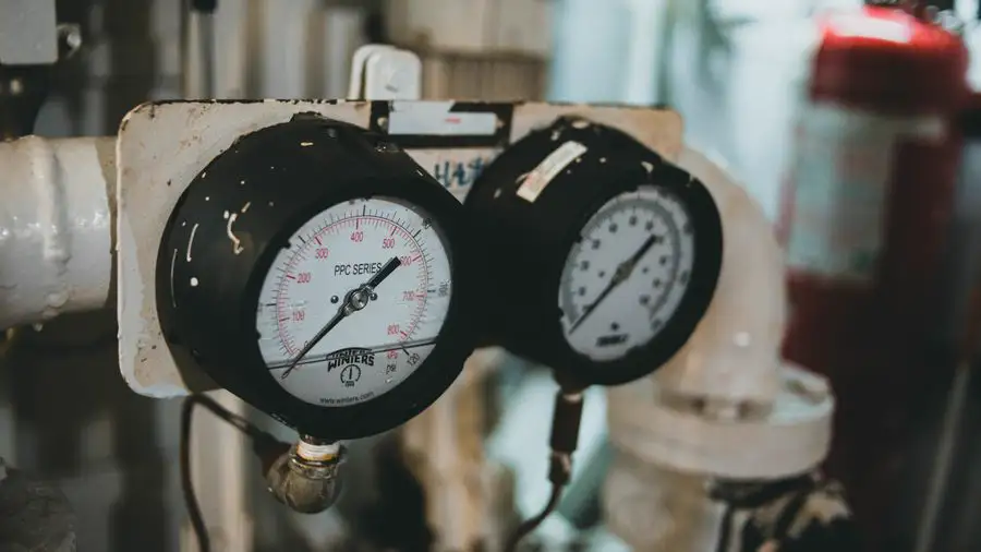 Two round pressure gauges mounted on a piece of equipment