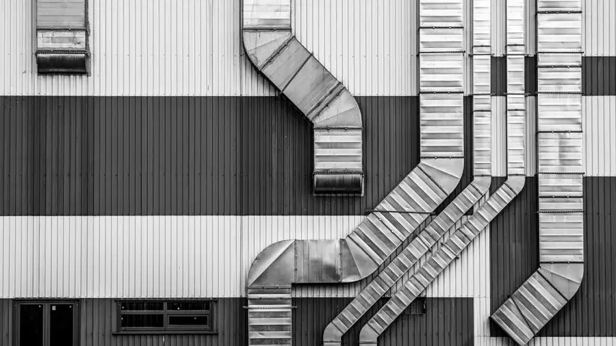 Metal air ducts running along the outside of a building