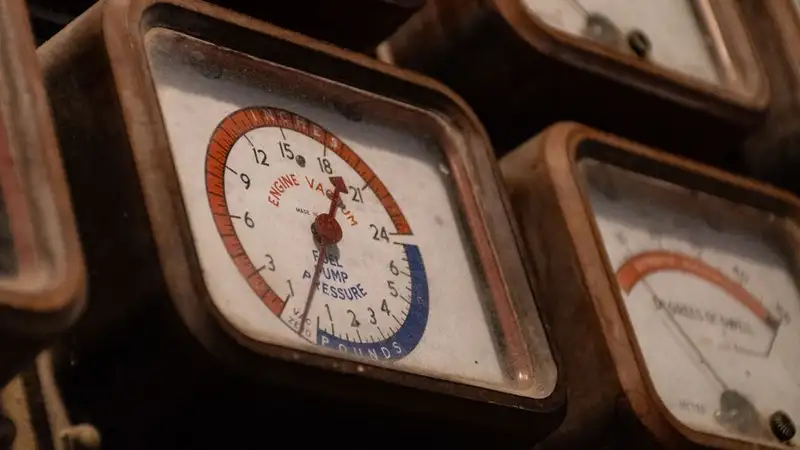 Row of old dial gauges with rusty cases