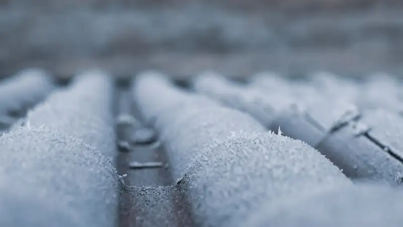 Frost covering ridged roof shingles, showing how frost builds up on a cold surface