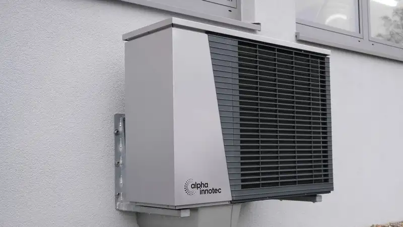 Outdoor air conditioning unit mounted on a residential building exterior