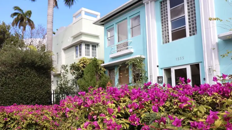 Art Deco architecture with vibrant bougainvillea in a sunny garden setting