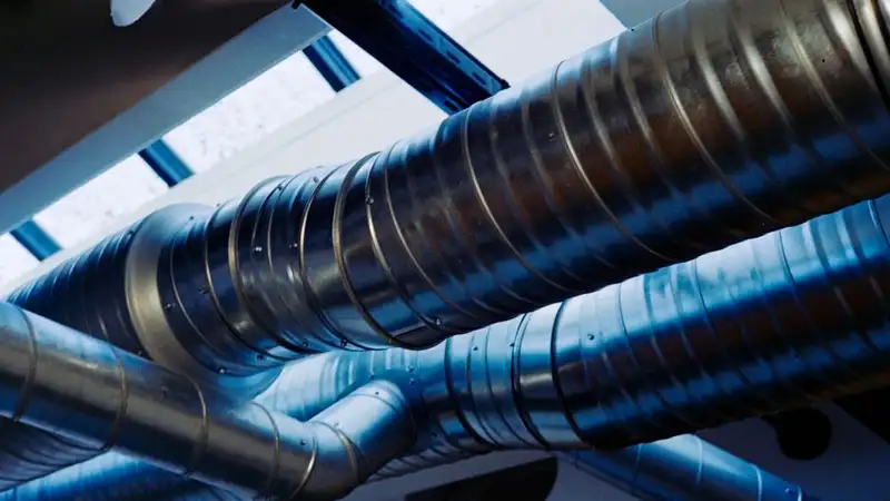 Close-up of a modern metallic ventilation system in an industrial setting