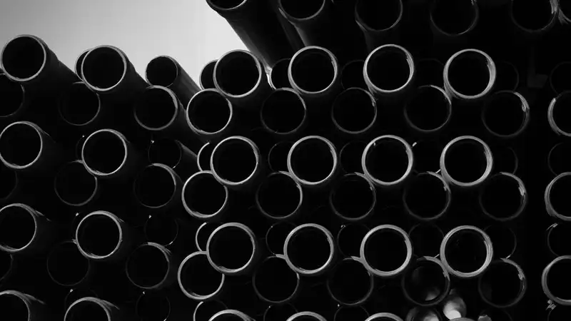 Artistic black and white image of stacked industrial pipes for creative projects
