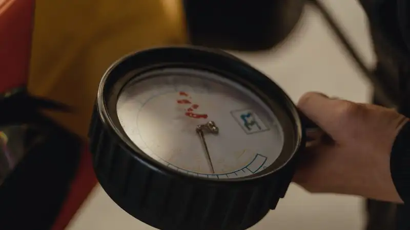 Detailed close-up of a hand holding a pressure gauge, ideal for mechanical themes