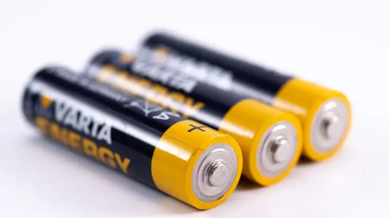High-quality image showcasing a close-up view of three alkaline batteries on a white surface