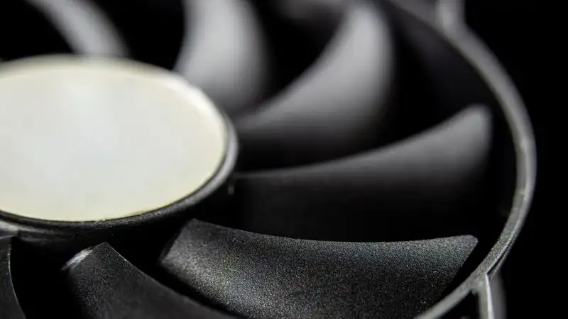Macro close-up of a modern computer cooling fan blade, showcasing intricate details